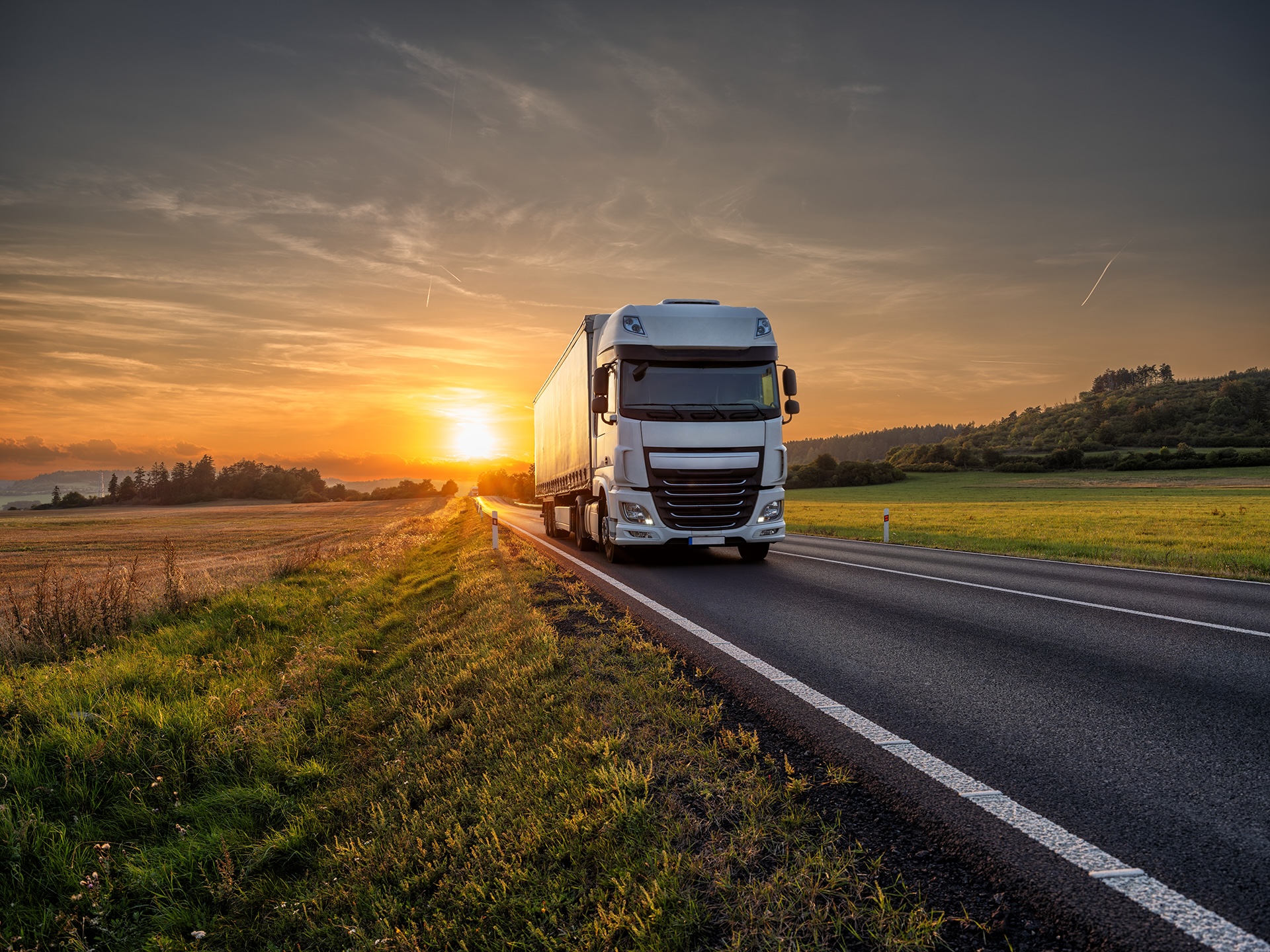 White,Truck,Driving,On,The,Asphalt,Road,In,Rural,Landscape