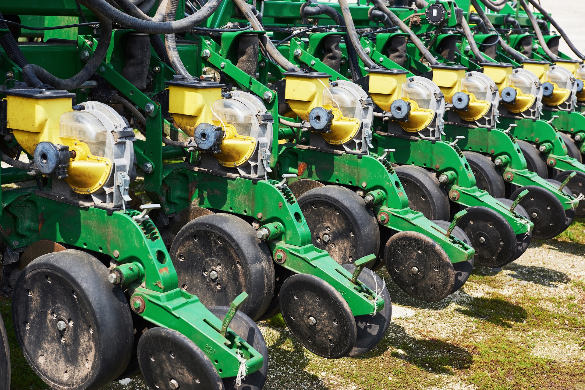 Close up of seeder attached to tractor in field. Agricultural machinery for spring works sowing