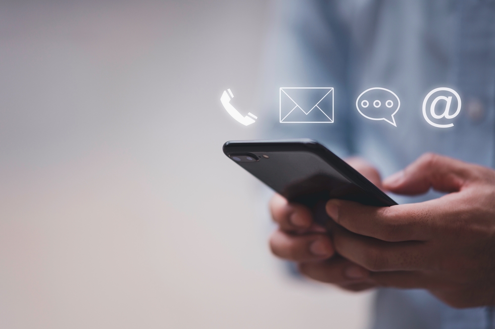 Businessman,Using,Smart,Phone,With,The,Email,,Call,Phone,,Address,
