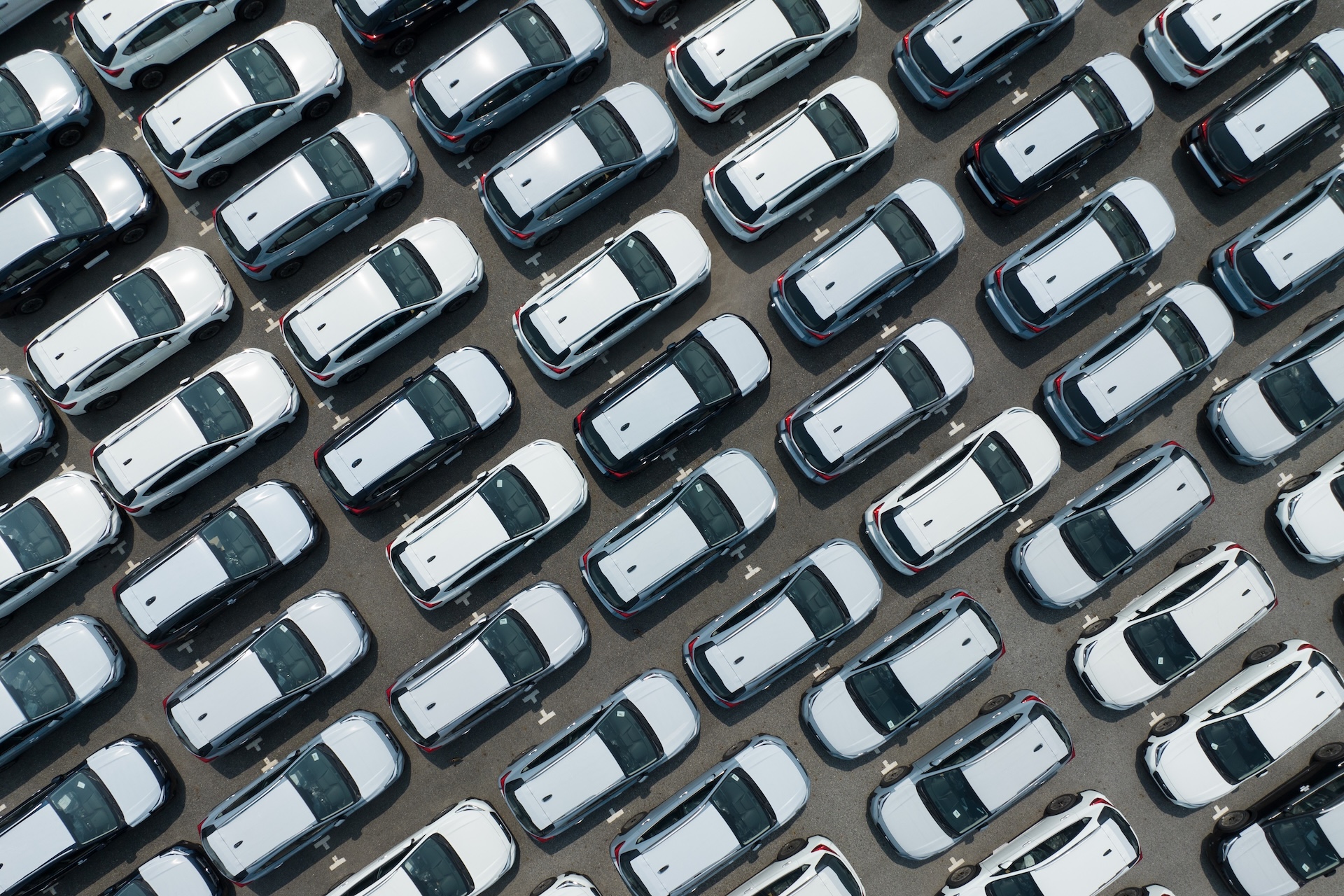 Aerial,View,Of,New,Cars,Stock,At,Factory,Parking,Lot.